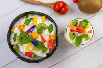 Fruit salad in a bowl on the wooden floor.