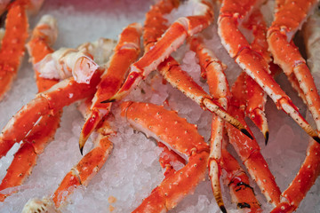Crab red legs on ice, fresh sea food background