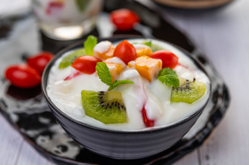 Fruit salad in a bowl on the wooden floor.