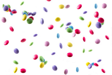 colorful sweets falling on white background