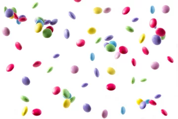 Gordijnen colorful sweets falling on white background © George