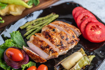 Chicken steak put on a black plate.