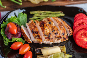 Chicken steak put on a black plate.