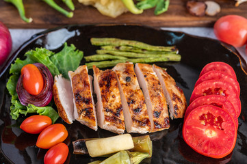 Chicken steak put on a black plate.