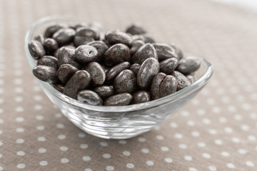 raisins in chocolate in a marble shiny glaze in a glass bowl