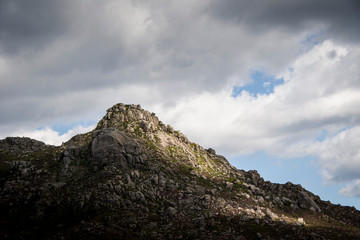 Fototapeta na wymiar A rocky mount peak under cloudy skies
