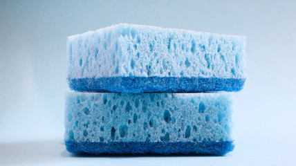 Two blue sponges used for washing and erasing dirt used by housewives in everyday life. They are made of porous material such as foam. Detergent retention, which allows you to spend it economically