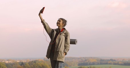 Hiker Woman taking photo smartphone