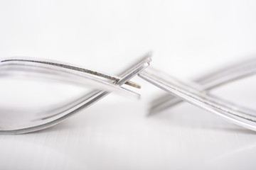 Close up detail of fork on white background, abstract art background design concept, connection and touching