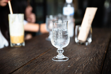 A glass of water, put water on the wooden table