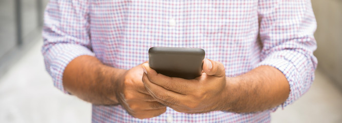 Close up. Young asian man using smartphone. searching or social networks concept.