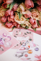 bouquet of pink and peach roses with cards for March 8