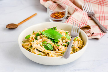 Spaghetti Pasta in White Sauce Garnished with Fresh Basil Leaves, Low Angle Close Up Photo
