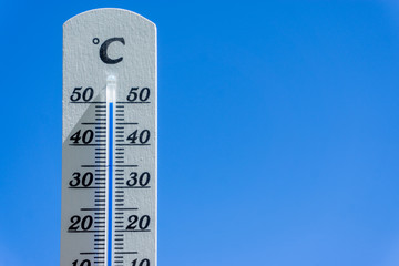 thermometer and sky, heatwave in summer