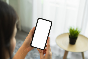 Mock up of woman hand holding smartphone and touching blank screen.
