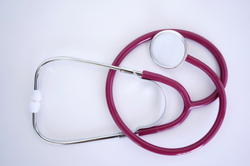 Stethoscope, phonendoscope isolated on a white background. Maroon stethoscope, phonendoscope for the doctor, for the diagnosis of lung disease, on an isolated background.