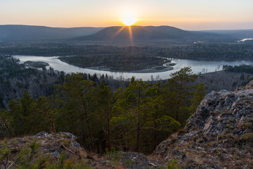Sunset in the Siberian forest overlooking the river