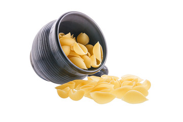 Conchiglie rigate pasta or seashell macaroni sipping from black bowl isolated on white background....
