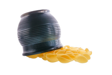 Conchiglie rigate pasta or seashell macaroni sipping from black bowl isolated on white background....