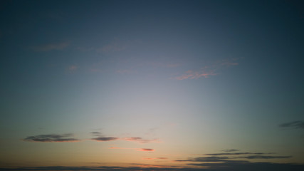 Clear,almost cloudless sky at sunset or sunrise with minimum of light strokes of clouds, with light...