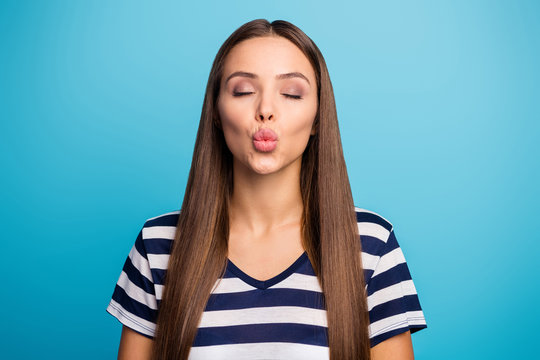 Closeup photo of pretty beautiful lady good mood flirty feminine person send air kisses handsome guy eyes closed wear white striped sailor t-shirt isolated blue background