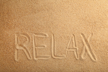 Inscription Relax in the sand on a tropical island.