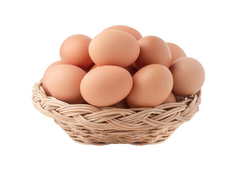 Raw eggs in the wicker basket isolated