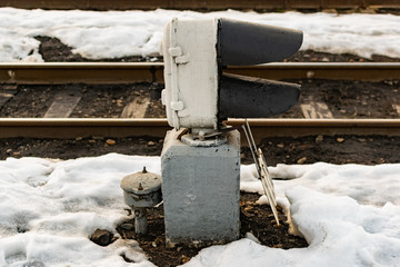 Railway station small traffic lights to reflect red and orange light to regulate the movement of trains and buggies on old rails and sleepers