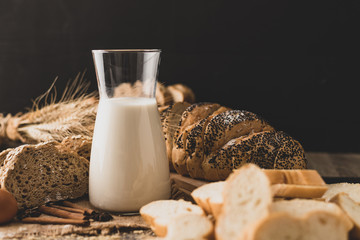 Milk in a glass bottle placed on a wooden table with ingredients