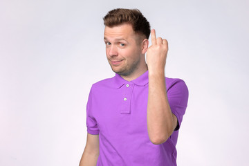 Caucasian young man showing empty ring finger being divorced