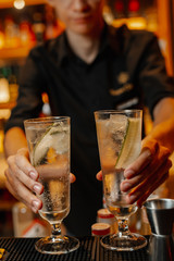 The bartender is preparing a cocktail. Close-up on hands