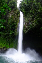 Long exposure of a large waterfall located in the center of an Amazon jungle
