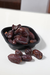 Dried dates fruits on white background, tasted sweet and chewy