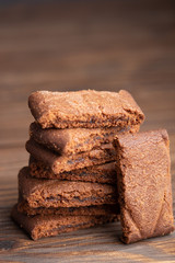 Chocolate home made cookies on the wooden table. Stacked chocolate chip cookies close up