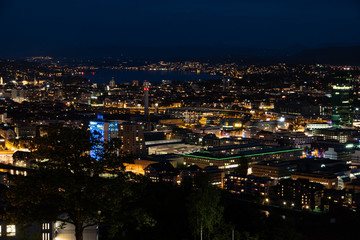 Fototapeta na wymiar Zurich city Switzerland view from famous vista point late evening blue hour evening after sunset cloudy sky