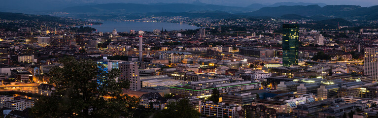 Obraz premium Zurich city Switzerland panorama from famous vista point late evening blue hour evening after sunset cloudy sky