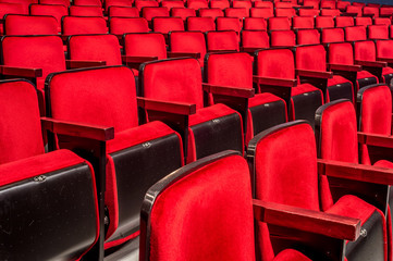 Rows of empty red seats in a theater