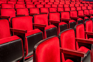 Fototapeta premium Rows of empty red seats in a theater