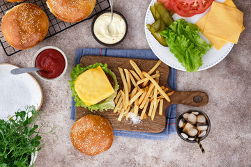 Burger with french fries and ingredients. Top view.