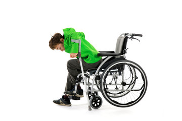 boy gets up from wheelchair , Wheelchair user gets up, moves away from the wheelchair , Young male person got up from a wheelchair as a result of rehabilitation
