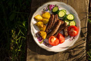 grilled meat with vegetables on a wooden table