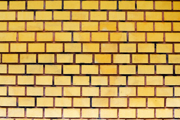 Obraz premium symmetrical orange brick wall. the exterior of the house. texture of rectangular bricks
