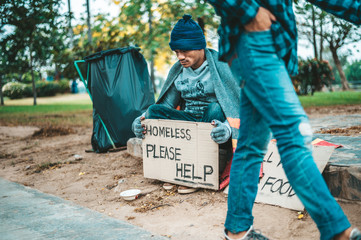 Beggars wrapped in cloth and then put on a hat and sat down beside the street and someone gave...