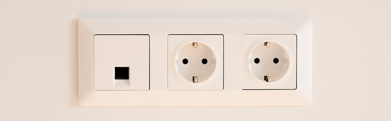 panoramic orientation of switch near power sockets on white