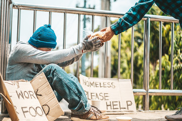 The man sitting begging on an overpass.