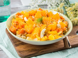 Fresh summer vegan quinoa bowl salad with baked spiced pumpkin, fennel, oranges and turmeric. Healthy gluten free lunch or dinner