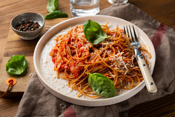 Whole wheat spaghetti on white plate