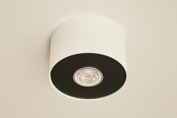halogen bulb in lamp on white ceiling in apartment