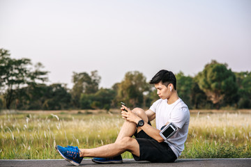 Men sitting and resting after exercising on the roadside.