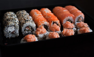 Pickled ginger and rol california. A big set of Japanese rolls with fish. Delivery of ready food. Advertizing of food